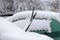 Cars covered with heavy snow in winter. Car wipers raised