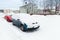 Cars covered with snow parked along winter street