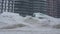 Cars covered by snow after a snow blizzard. Residential building in the background.