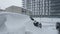 Cars covered by snow after a snow blizzard. Residential building in the background.