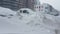 Cars covered by snow after a snow blizzard. Residential building in the background.