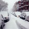 cars covered in snow after snowstorm.