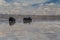 Cars crossing Uyuni, the largest salt flat in the world