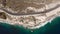 Cars drive along coastal shoreline in Summer