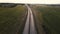 cars drive along the highway among the fields. aerial shooting