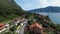 Cars drive along the highway of the resort town at the foot of the mountains on the seashore