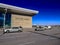 Cars drive along the road past a building with a signboard Esenboga Airport. Beautiful city