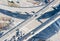 Cars drive along traffic intersection in city, aerial view.