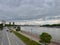 Cars drive on highway near water with bridge in Serbia