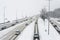 Cars drive on a snowy road