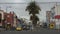 Cars driving along an avenue in the commercial area of the Riobamba city