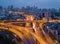 Cars driving on bridge roads shaped curve highways with skyscraper buildings. Aerial view of Expressway Bangna, Klong Toey in