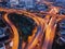 Cars driving on bridge roads shaped curve highways with skyscraper buildings. Aerial view of Expressway Bangna, Klong Toey in