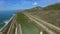 Cars driving down the highway near the plantation corn field near the Pacific ocean