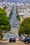 Cars driving down steep roads in San Francisco in neighborhood