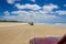 Cars driving on the main transportation highway on Fraser Island - wide wet sand beach coast facing Pacific ocean - long 75 miles