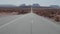 Cars Driving On Road Along To Butte And Mesa Mountains In Monument Valley Usa