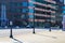 Cars driving on a street lined with tall black light posts and glass buildings in downtown Atlanta