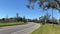 Cars driving through a suburban neighborhood on a curved road