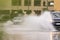 Cars driving trough big water pond after heavy rains fall in Dubai