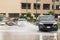 Cars driving trough big water pond after heavy rains fall in Dubai