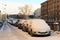 Cars on the embankment, noticeable by snow