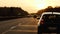 Cars on German autobahn highway at sunset orange