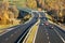 Cars on the highway leading across the bridge over the valley, electronic toll gates, top view