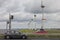 Cars at highway passing big windturbines near Dutch lake IJsselmeer