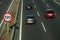 Cars on highway and SPEED LIMIT signpost in Madrid