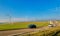 Cars on a highway and wind turbines in the background - France