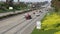 Cars on interstate highway California USA. Intercity freeway transport. Road traffic and greenery.