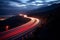 Cars light trails at night in a curve asphalt road at night. Long exposure image of a highway at night