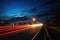 Cars lights in movement on the road at night time. Timelapse, hyperlapse of transportation. Motion blur, light trails