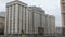 Cars are moving on street in front of building of State Duma of Russia in Moscow