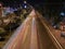 Cars at night on  highway rope lights and illuminated signs