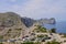 Cars parked along road winding up to lighthouse at Cap de Formentor. Majorca, Spain.