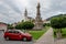 Cars parked in front of Kostol sv. Katariny Alexandrijskej Church and Morovy stlp sv. Trojice memorial in center of Kremnica city