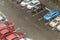 Cars parked at a parking lots near high-rise building under heavy shower rain and hurricane wind