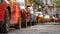 Cars parked on street in a city in sunny summer day