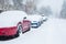 Cars parked and trapped under a deep blanket of snow in unexpected snow storm.