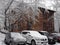 Cars in the Parking lot of an old wooden house in winter