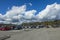 Cars on parking spot on gorgeous blue sky with white clouds background