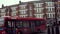 Cars and red Double-decker buses circulating at the Roundabout at Muswell Hill Broadway, London, England