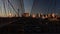 Cars riding and pedestrians walk over the Brooklyn Bridge at sunset