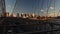 Cars riding and pedestrians walk over the Brooklyn Bridge at sunset