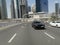 Cars in road and skyscrapers in background