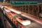 Cars speeding on the Brooklyn Bridge - New York by night