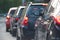 Cars stopping in front of a red traffic light