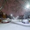 Cars and streets covered in snow in night image of Filomena storm fall in Madrid Spain. Winter